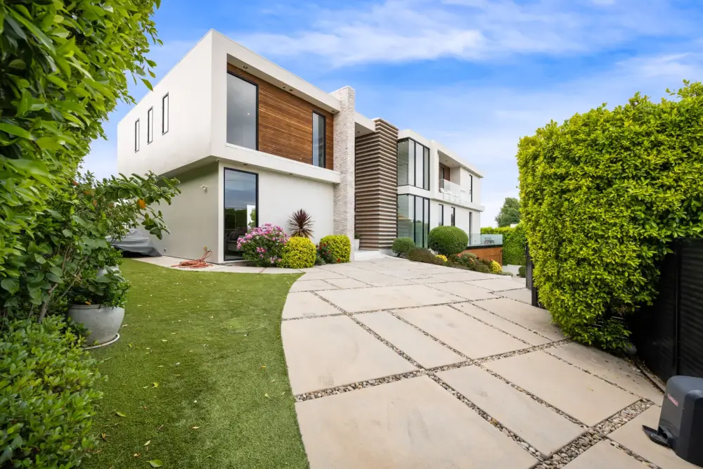 Contemporary home driveway with landscaped garden